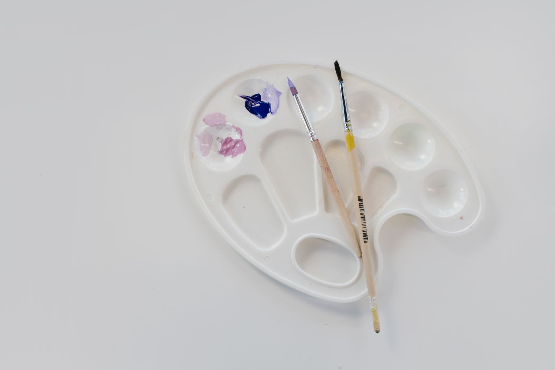 Fine brush applying acrylic paint detail for hand-painted allotment furniture motifs